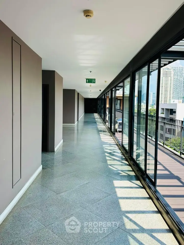 Spacious modern corridor with large windows and city view