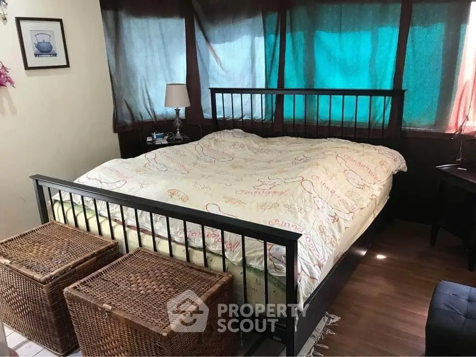 Cozy bedroom with double bed and wicker storage baskets, perfect for a restful retreat.