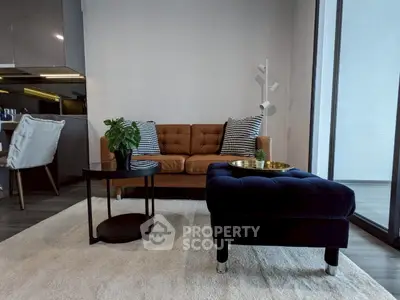 Modern living room with stylish furniture and large windows