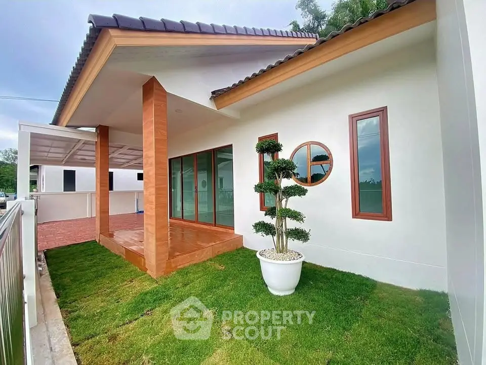 Charming modern house with lush green lawn and elegant entrance