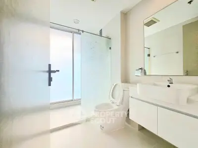 Modern bathroom with sleek fixtures and frosted glass shower door