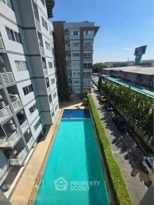 Modern apartment building with pool and city view