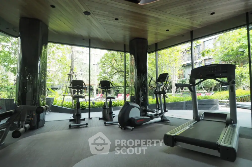 Modern gym with state-of-the-art equipment and lush garden views.