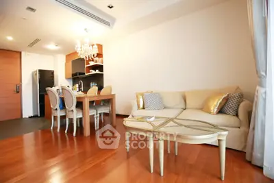 Elegant living room with hardwood floors, cozy sofa, and dining area in modern apartment.