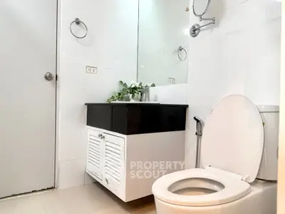 Modern bathroom with sleek fixtures and elegant vanity in a contemporary home.