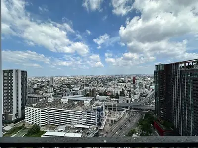 Stunning cityscape view from high-rise balcony with clear blue sky