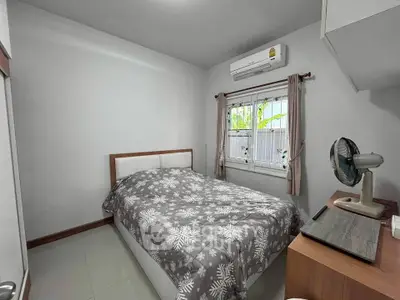 Cozy bedroom with air conditioning and modern decor, perfect for a restful retreat.