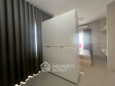 Modern bedroom with sleek wardrobe and natural light