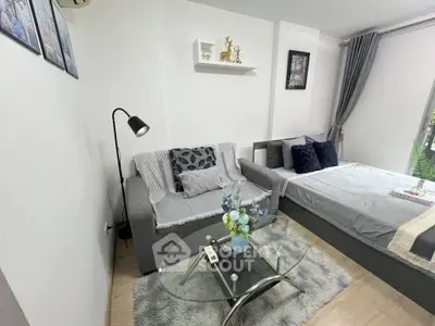 Modern studio apartment with cozy living area and stylish decor