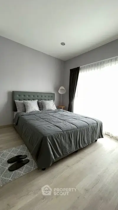 Modern bedroom with stylish decor and natural light