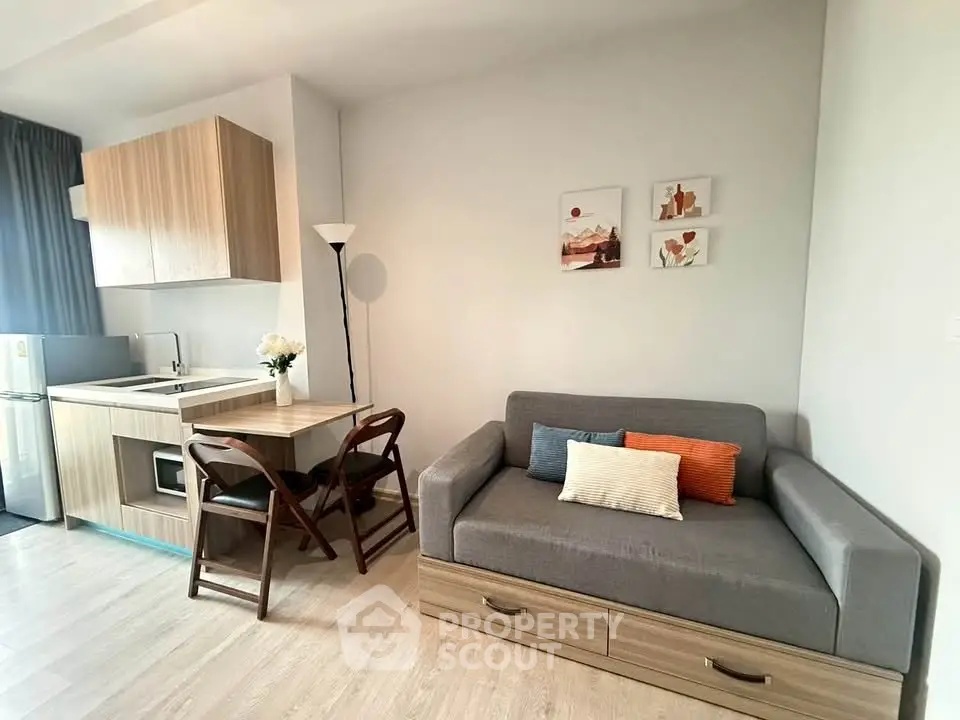 Modern studio apartment with cozy living area and compact kitchen