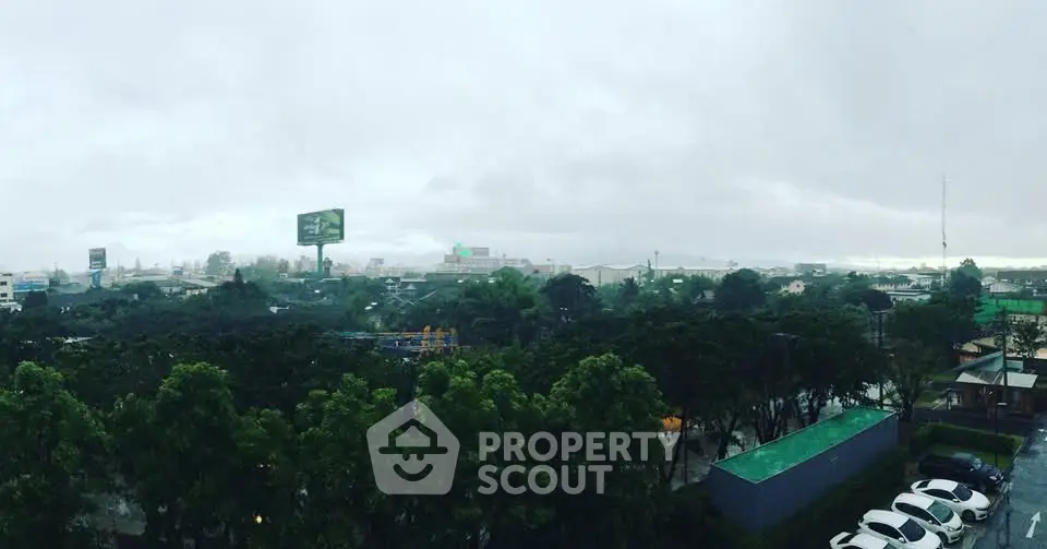 Scenic cityscape view with lush greenery and overcast sky