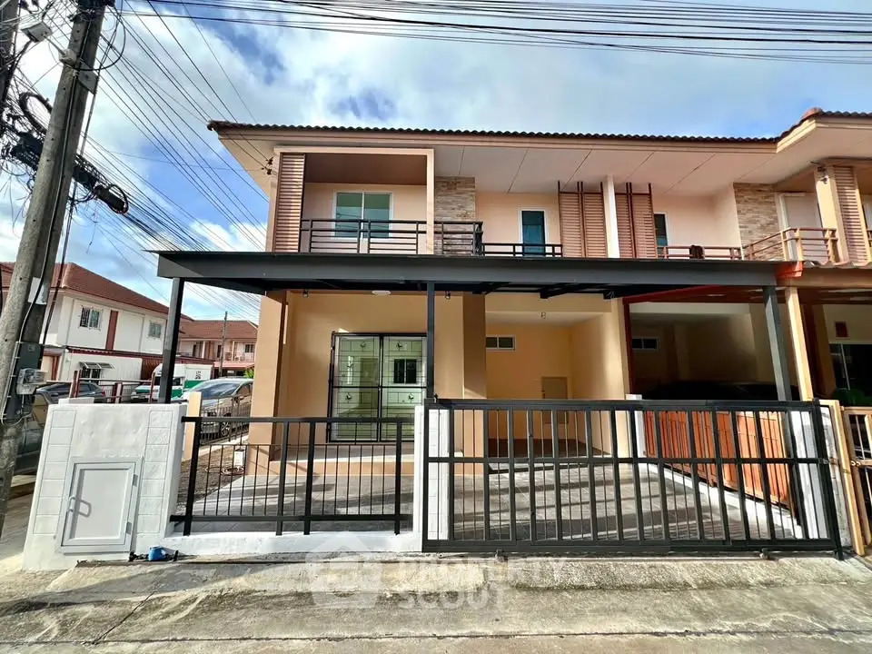 Modern two-story house with spacious driveway and balcony in a suburban neighborhood.