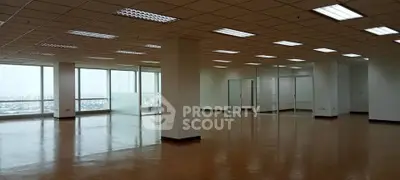 Spacious open-plan office space with large windows and city views, ideal for modern businesses.
