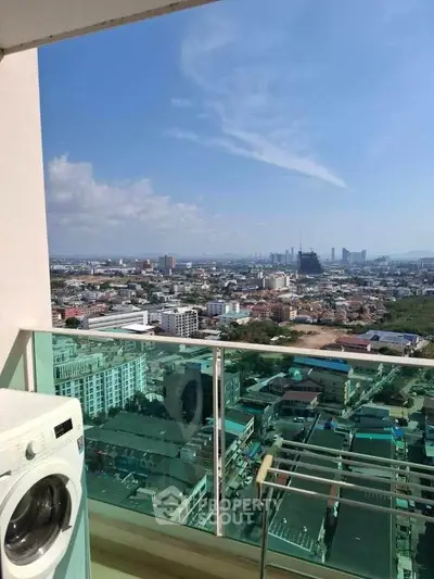 Stunning high-rise balcony view with cityscape and washing machine, perfect for urban living.
