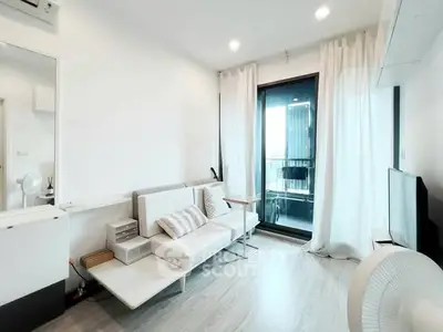 Modern living room with sleek furniture and balcony access, featuring bright natural light and minimalist design.