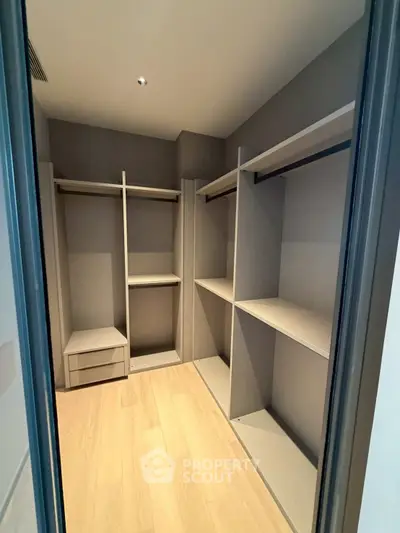 Spacious walk-in closet with modern shelving and ample storage space.