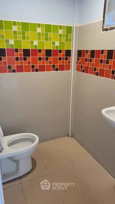 Vibrant bathroom with colorful tile accents and modern fixtures.