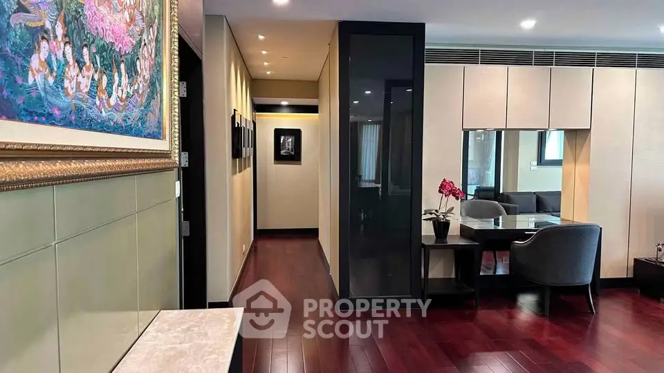 Elegant dining area with hardwood floors and modern decor in a luxurious apartment.