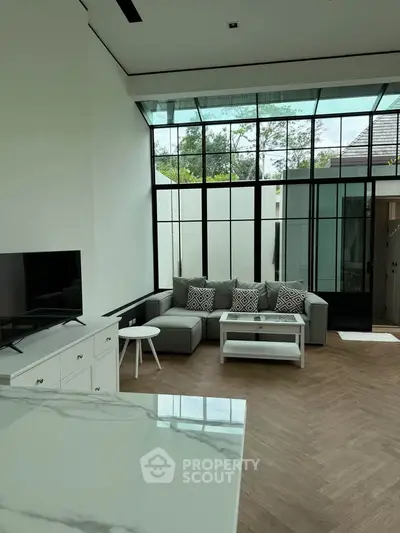 Spacious modern living room with large windows and stylish decor