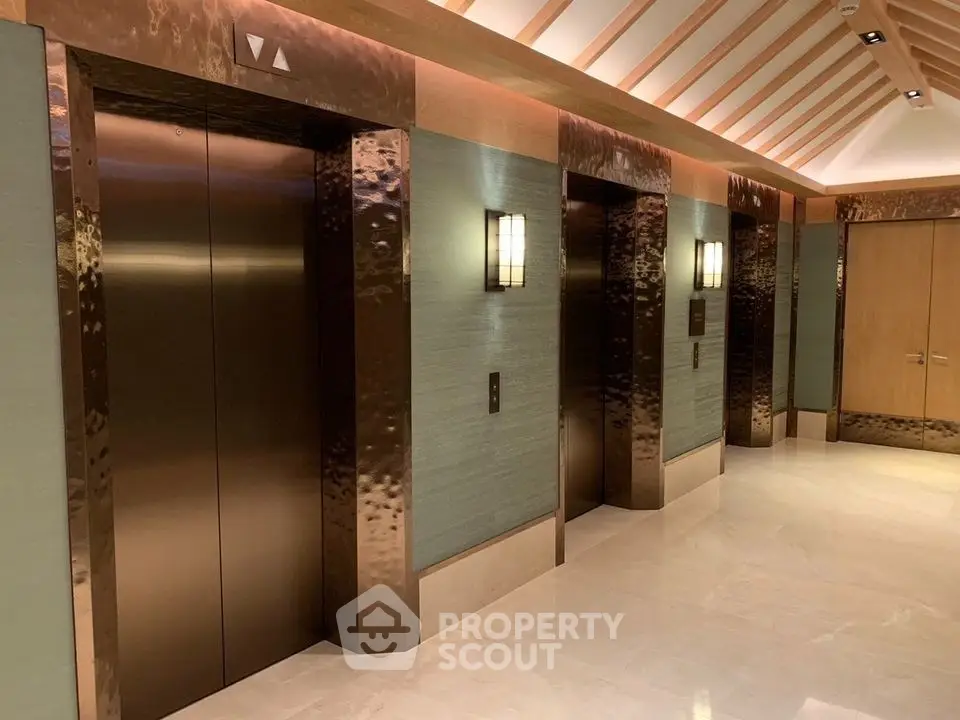 Luxurious elevator lobby with elegant lighting and polished finishes in a modern building.