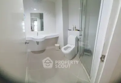 Modern bathroom with sleek fixtures and glass shower enclosure