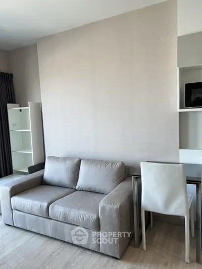 Modern living room with gray sofa and sleek furniture design
