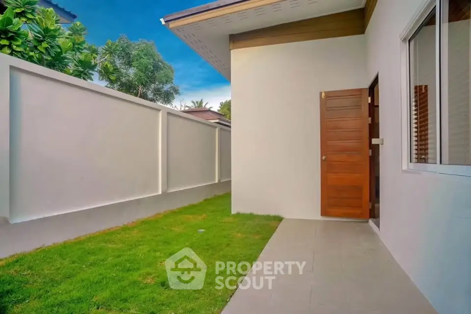 Charming backyard with lush green lawn and modern exterior design