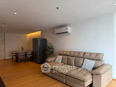 Spacious modern living room with elegant sofa and dining area