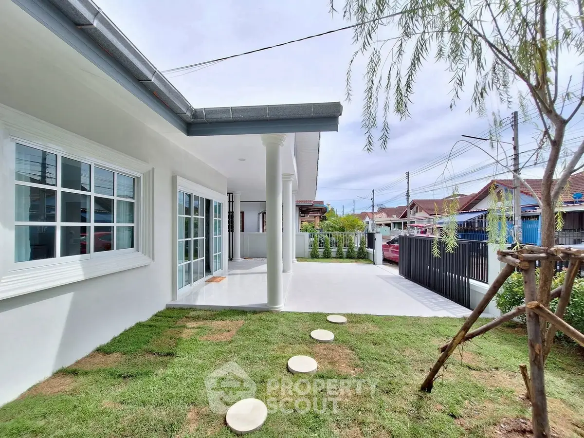 Charming single-story home with spacious garden and modern exterior design.