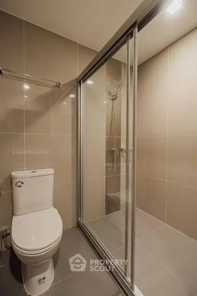 Modern bathroom with sleek shower and toilet in neutral tones