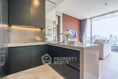 Modern kitchen with sleek design and city view from living room.