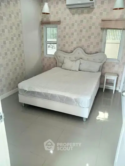 Cozy bedroom with elegant headboard and modern decor