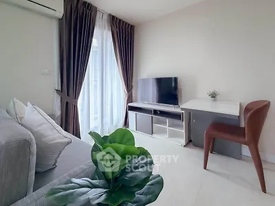 Modern living room with sleek furniture and natural light, perfect for relaxation and entertainment.