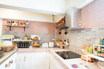 Charming kitchen with pastel tiles and modern appliances, perfect for culinary enthusiasts.