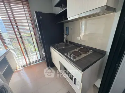 Modern kitchen with sleek appliances and large windows for natural light