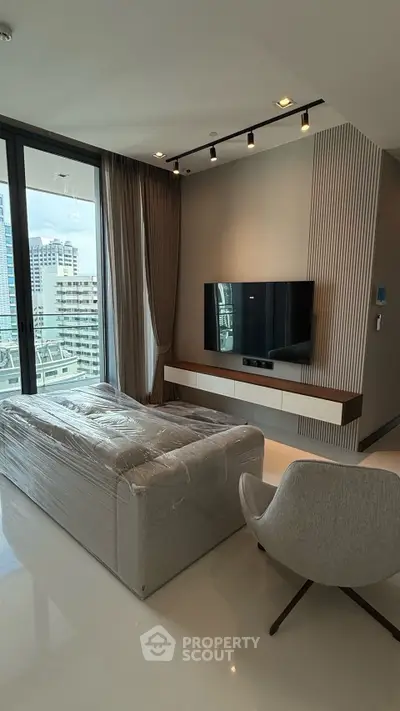 Modern living room with sleek design and city view from large windows.