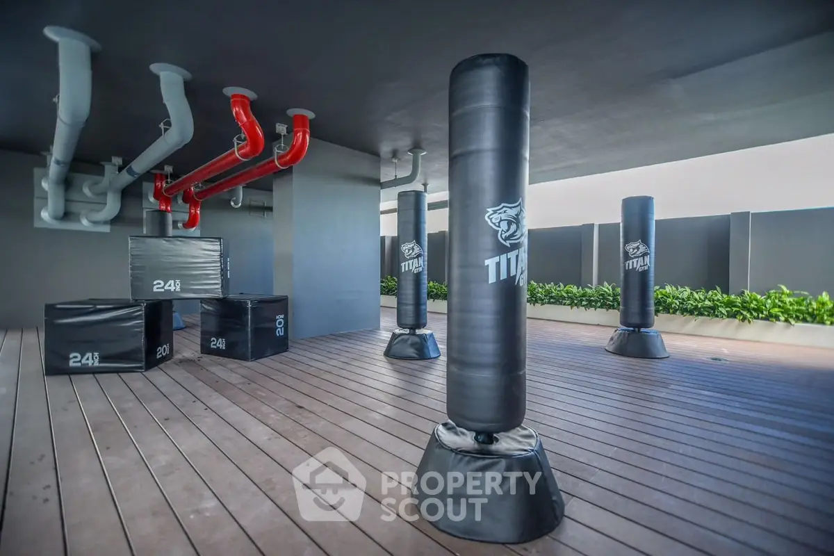 Modern rooftop gym with punching bags and exercise equipment