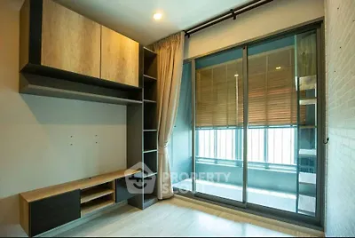 Modern apartment interior with large window and built-in shelving