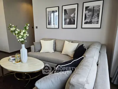 Elegant living room with stylish gray sofa, chic decor, and framed art on the wall, perfect for modern living.