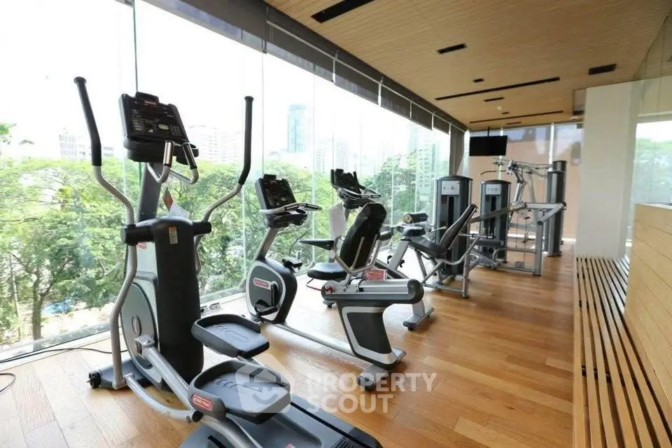 Modern gym with state-of-the-art equipment and panoramic city views.