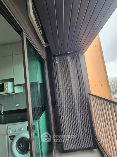 Modern apartment balcony with washing machine and city view