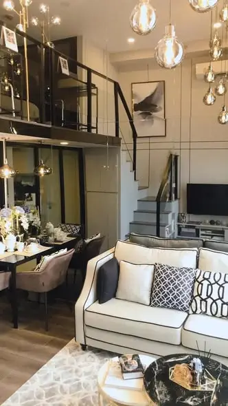 Luxurious modern living room with mezzanine, elegant decor, and stylish lighting in a chic apartment.