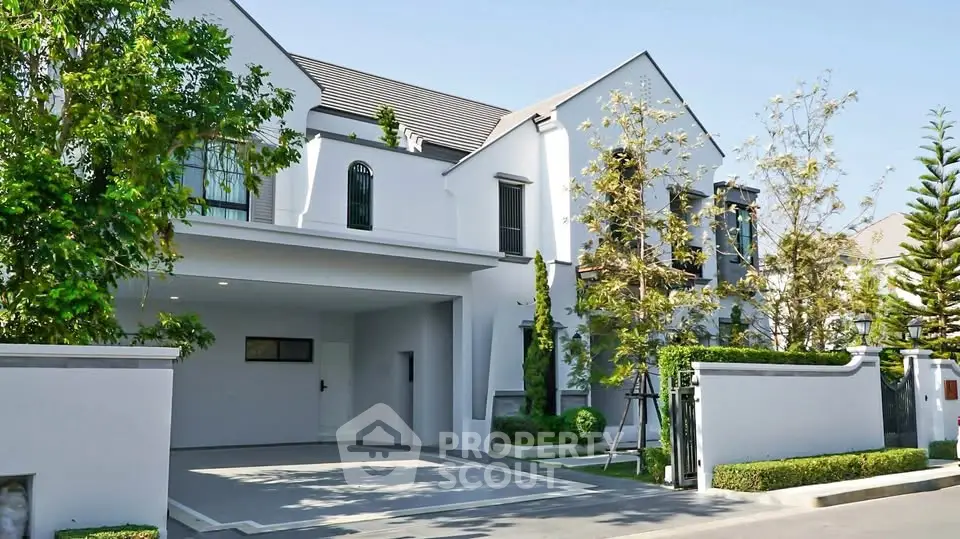 Elegant modern house exterior with lush greenery and spacious driveway