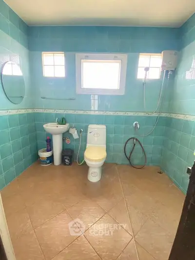 Spacious bathroom with blue tiles and modern fixtures