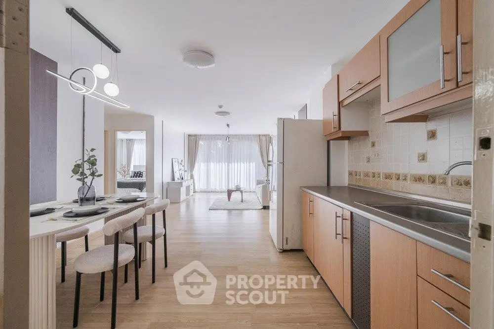 Spacious open-plan kitchen and dining area with modern decor and natural light.