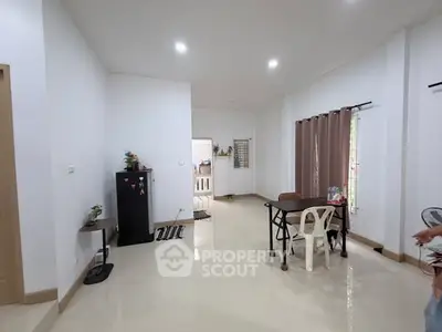 Spacious living room with modern decor and ample natural light