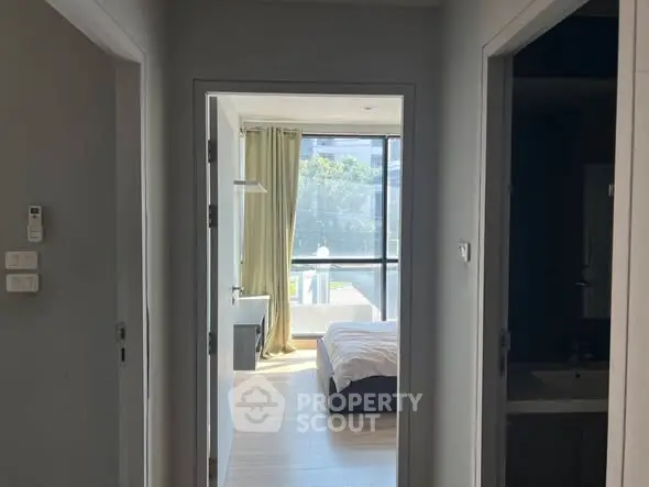 Bright bedroom with large window and modern decor, inviting natural light.