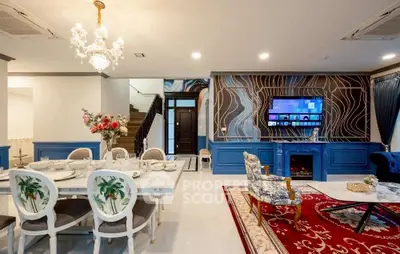 Luxurious living room with elegant dining area, chandelier, and modern decor