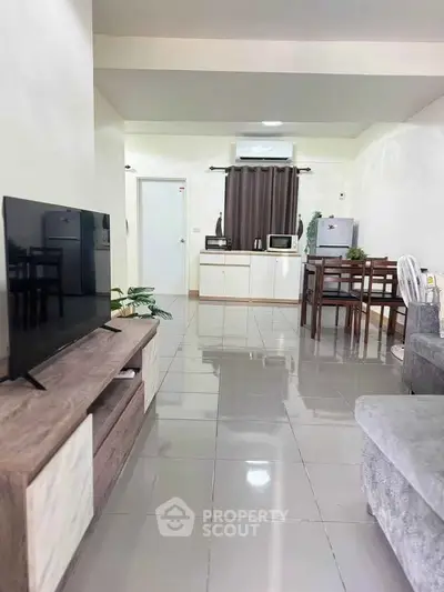 Spacious living room with modern furniture and open kitchen layout